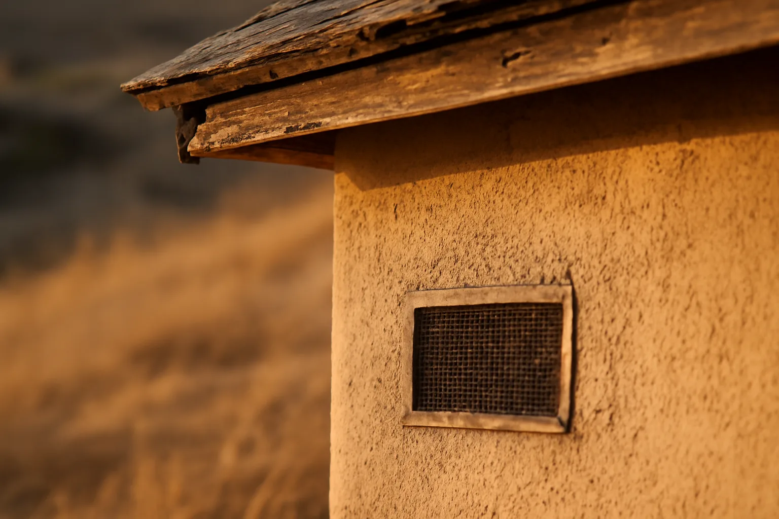 Close-up of a fire resistant home ventilation mesh vent installed under a house eave